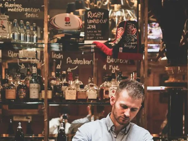 Bartender mixing cocktails behind the bar